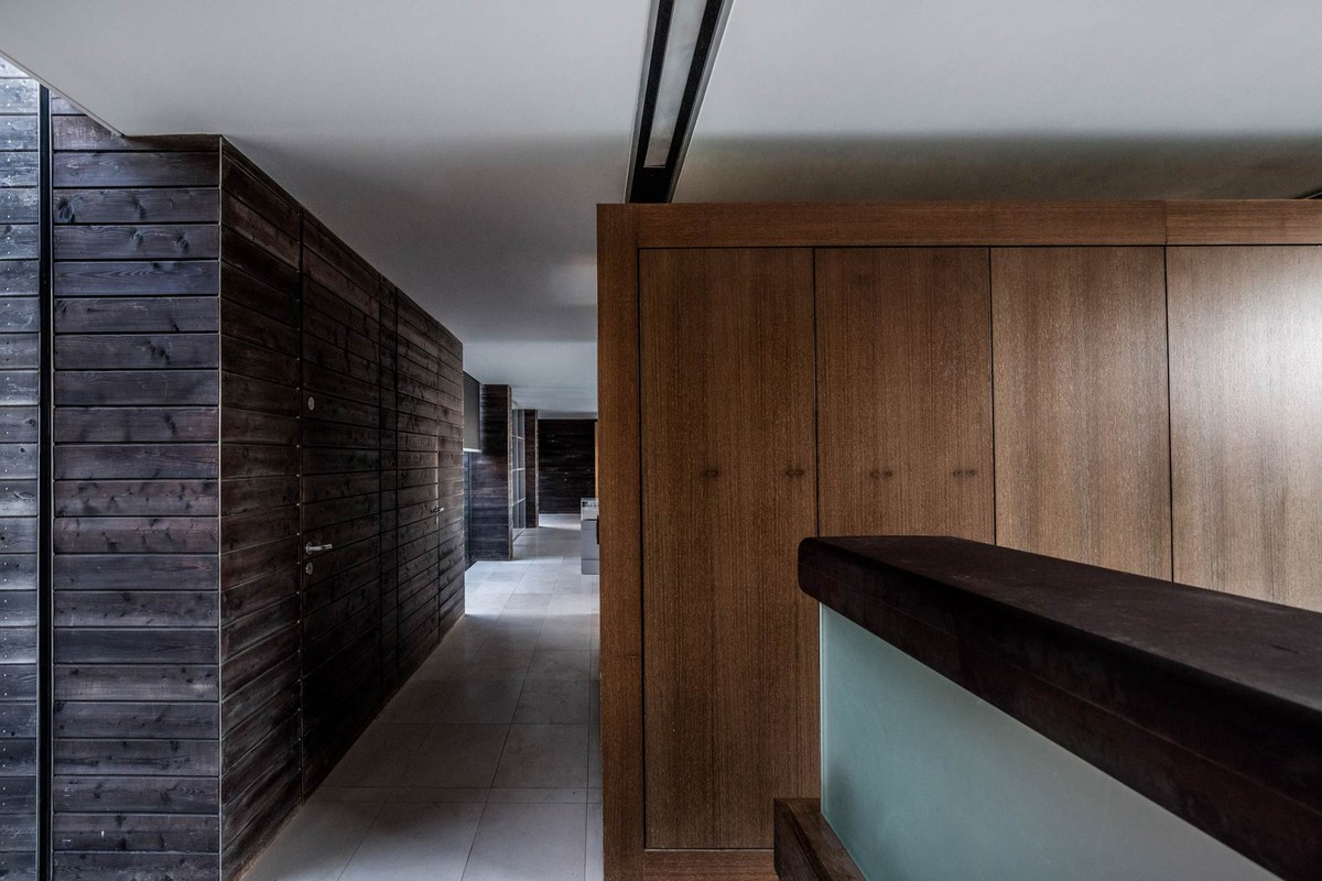 Hallway lined with dark timber and oak