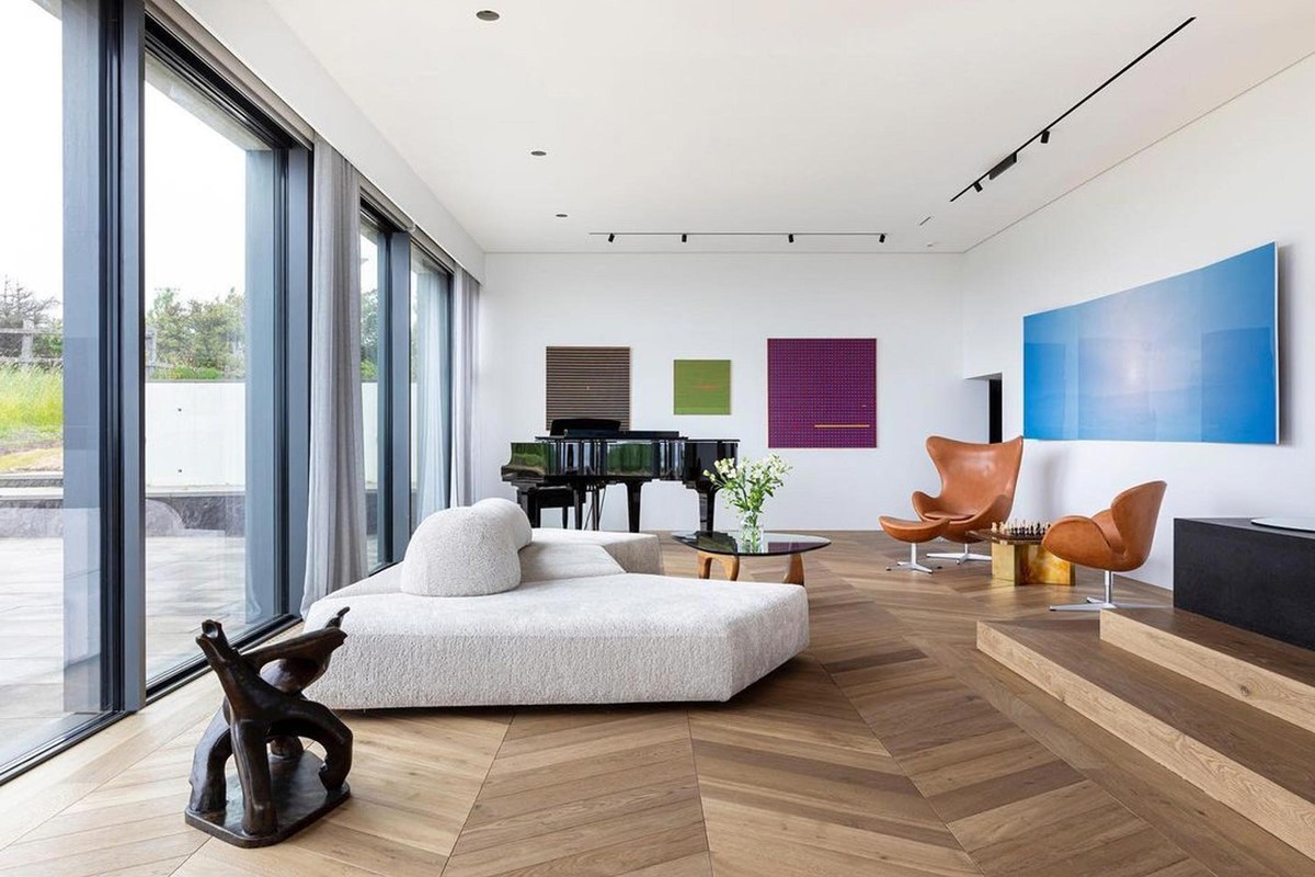 Bright living room with a grand piano and white sofa