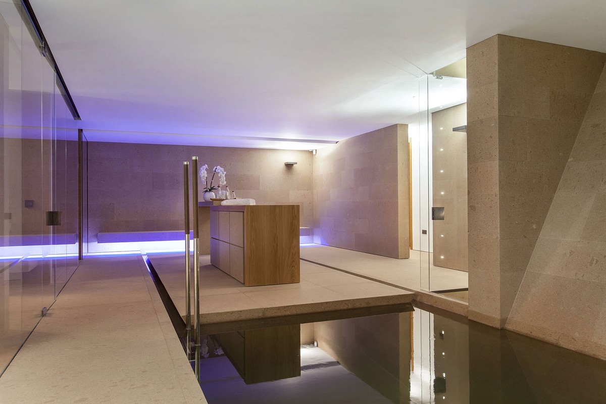 Spa area with a plunge pool and violet lighting