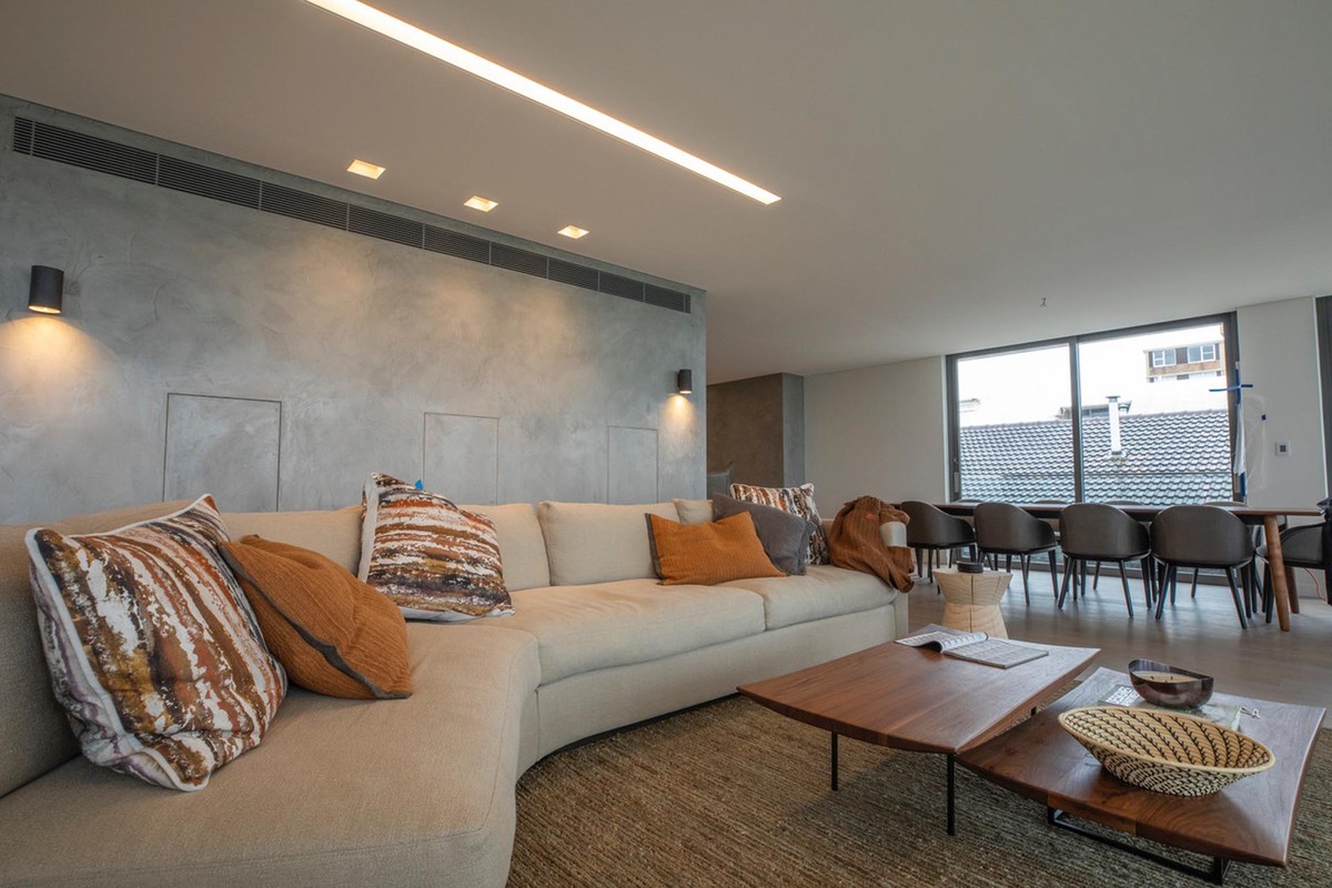 Penthouse living room with a corner sofa and dining area