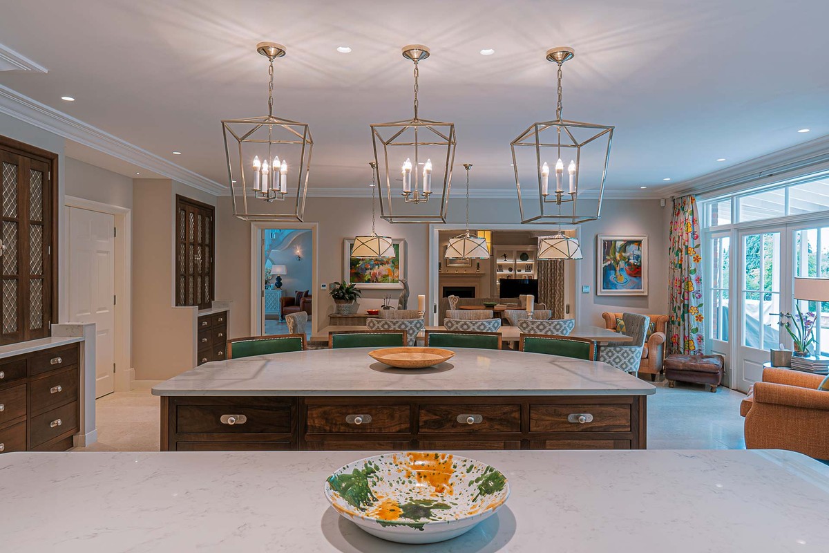 Kitchen with a white marble island and pendant lights