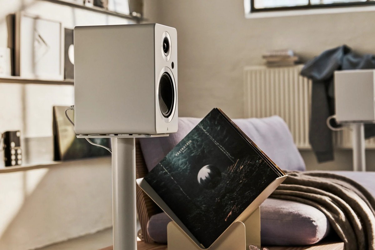 White speaker on a white stand in a bright living room