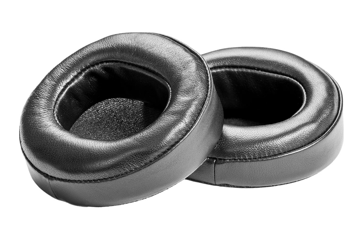 Pair of leather ear pads seen from a three-quarter angle, white background