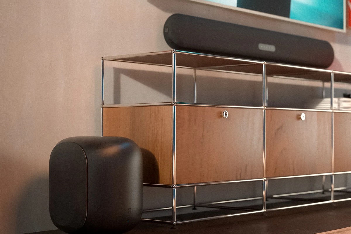 Subwoofer set under a metal shelf in a living room