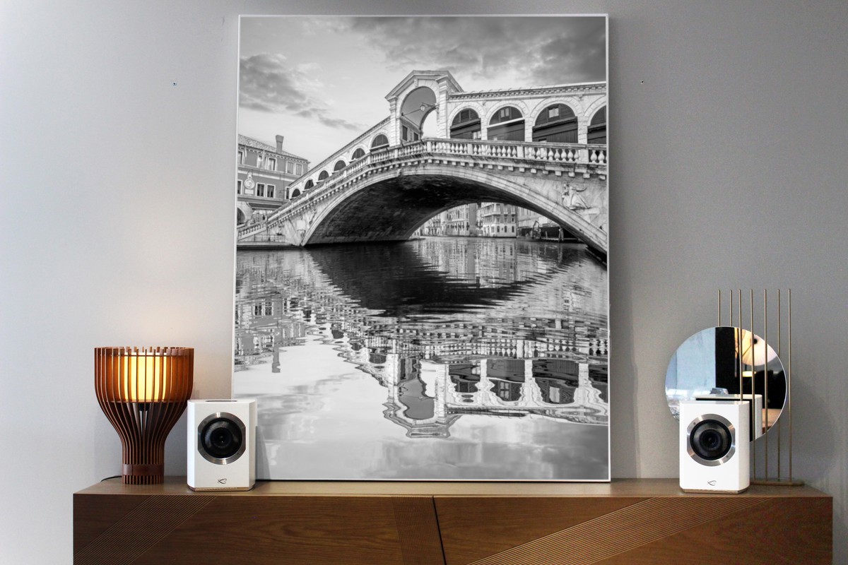 Two white speakers either side of a photograph of the Rialto bridge