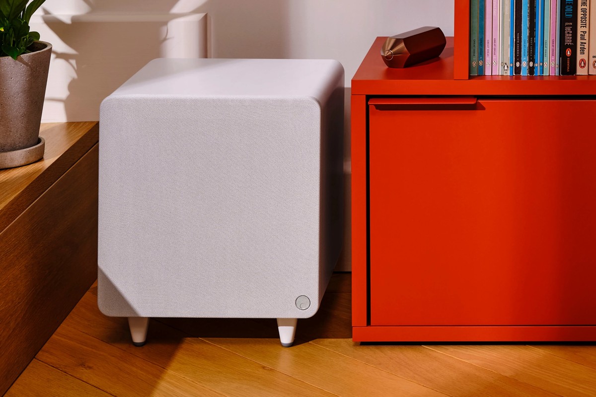 Subwoofer MSX Sub 300 bianco accanto a un mobile rosso e a una libreria