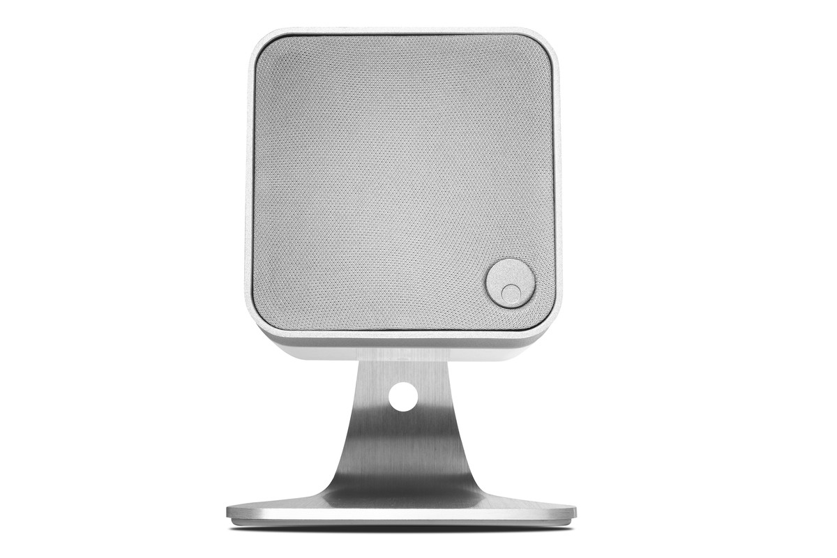 White Cambridge Audio Min 12 speaker standing on an aluminium table stand