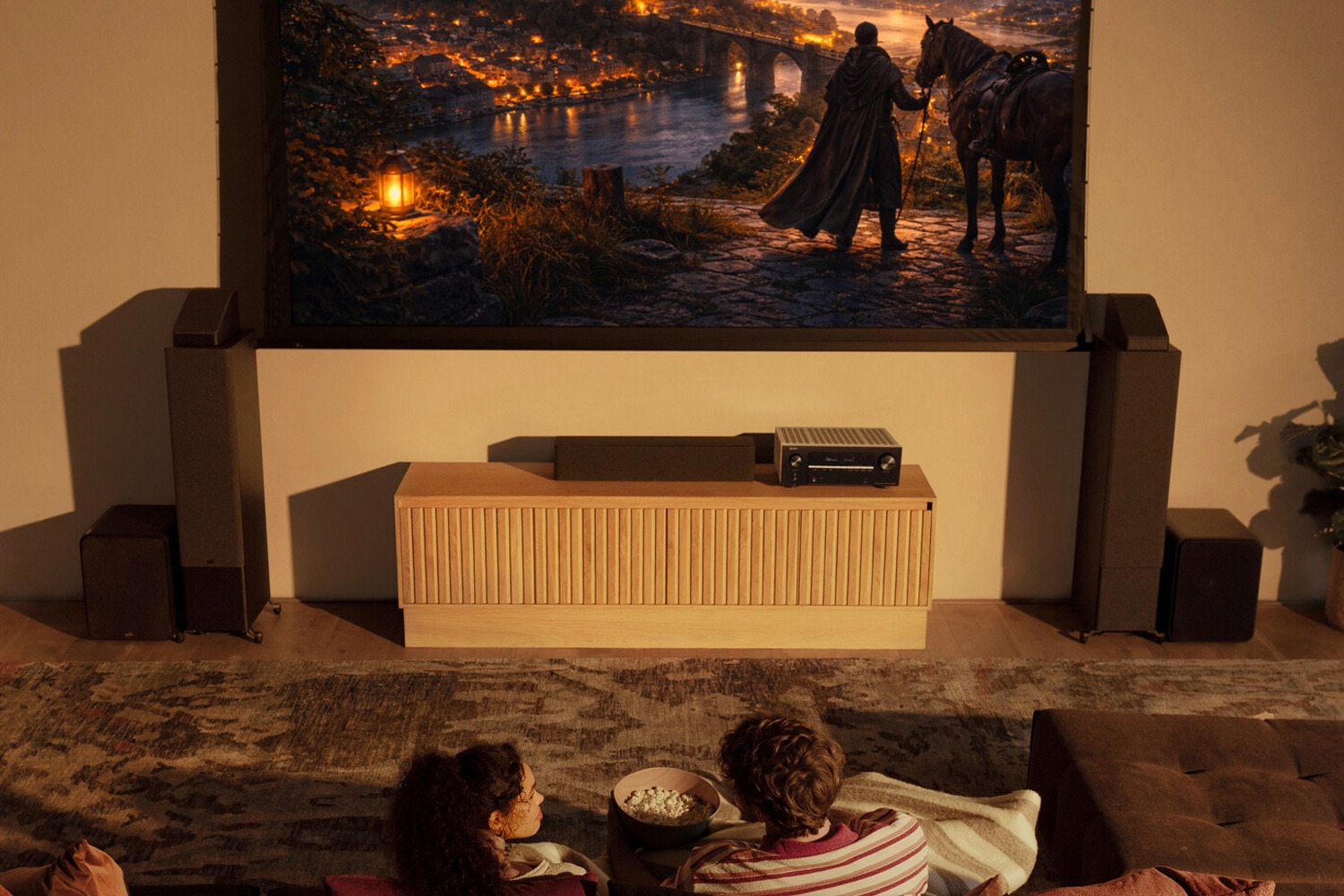 Home cinema room with screen, speakers and a black AV amplifier