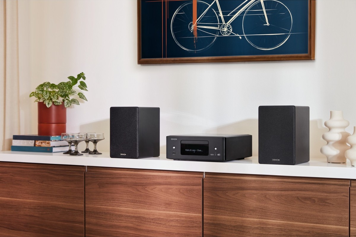 Micro system with two compact speakers on a living room shelf