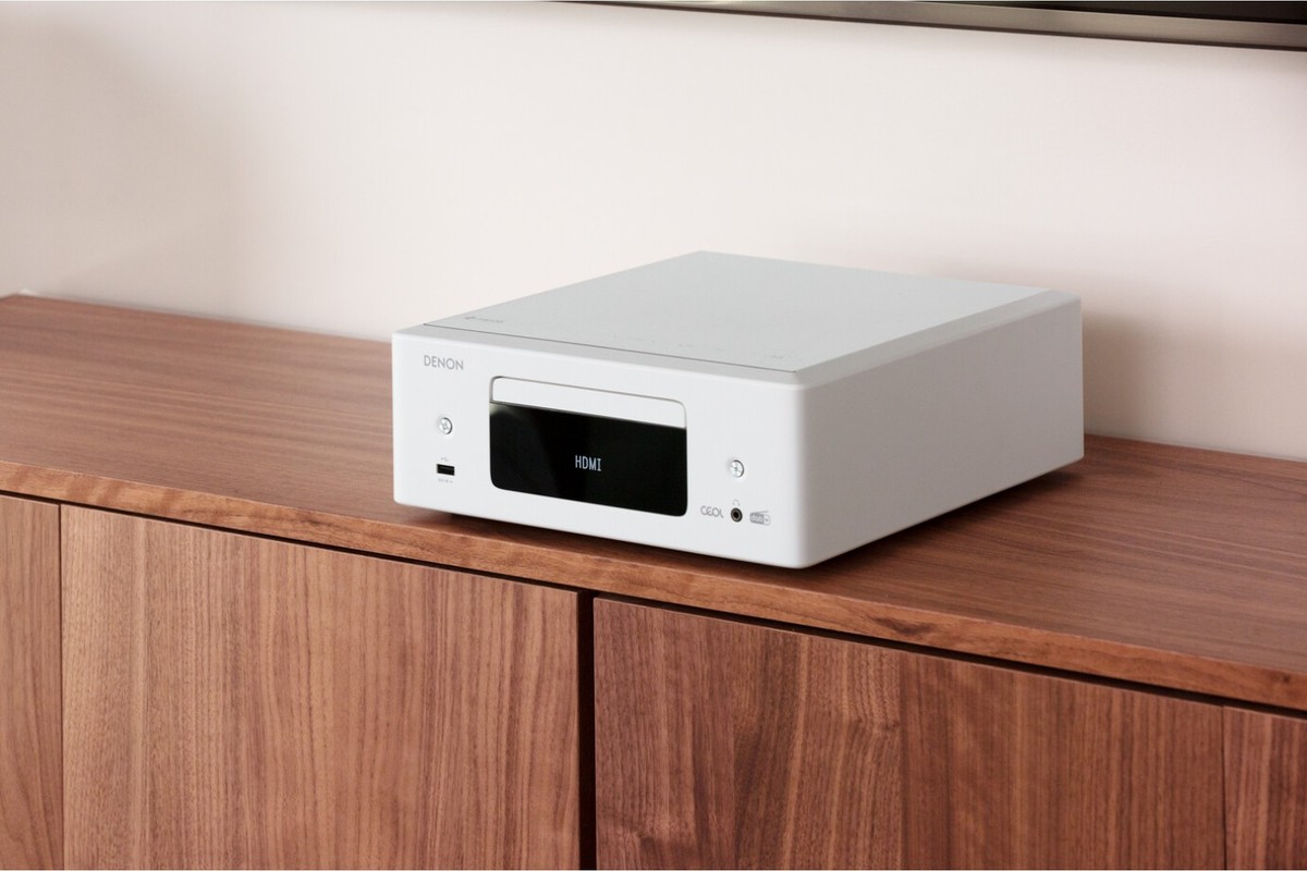 White CD receiver on a walnut sideboard