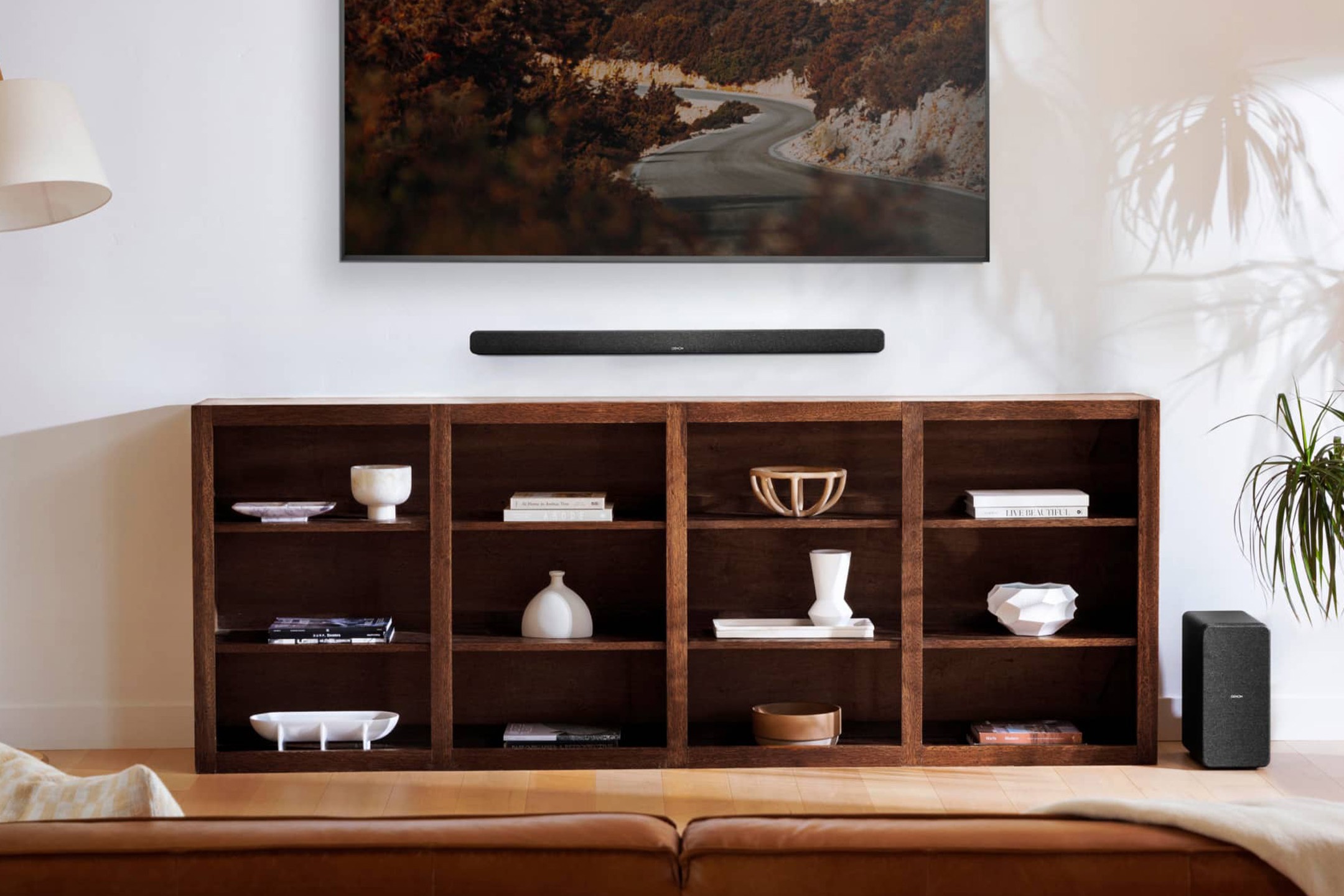 Soundbar and subwoofer beneath a large TV in a living room