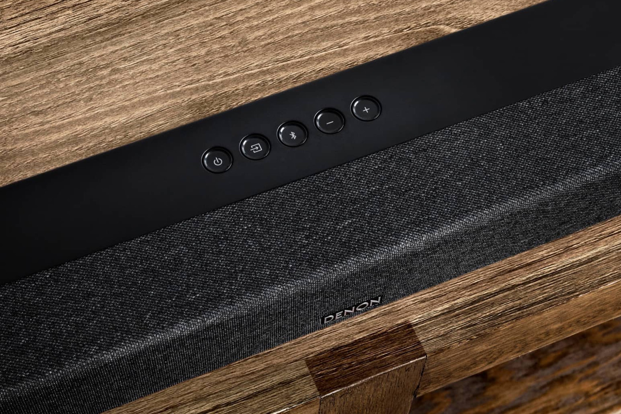 Denon DHT-S517 soundbar on a wooden TV unit