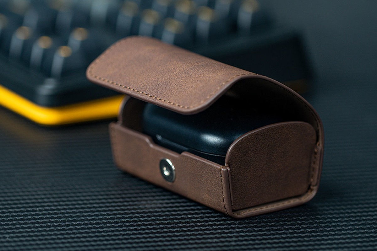 FiiO SK-FW5 faux leather case half open with a black box inside, in front of a keyboard