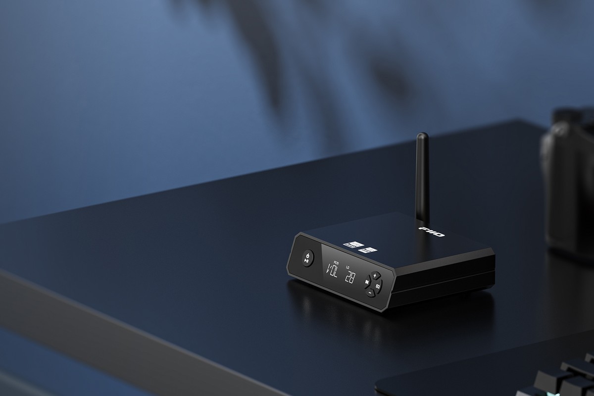 Récepteur noir posé sur un bureau bleu foncé