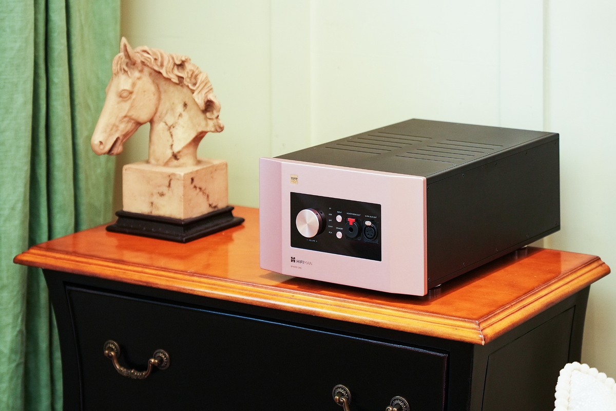 EF1000DAC standing on a wooden chest of drawers in a living room