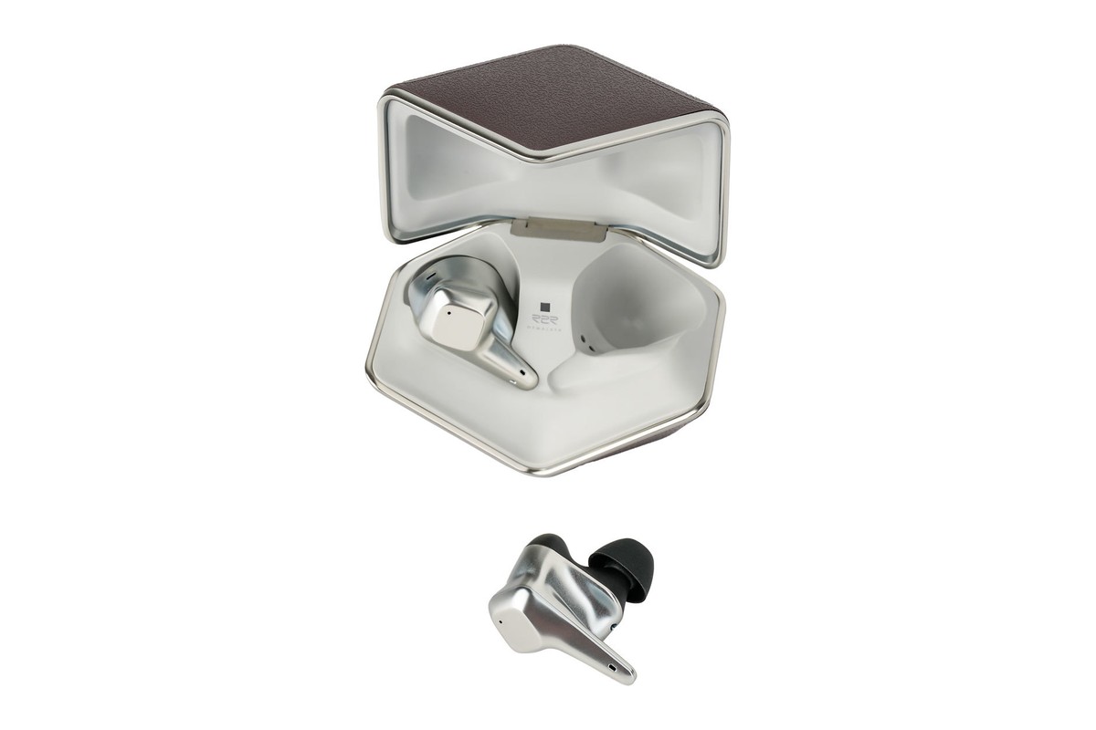 Open charging case with a silver earbud in the foreground