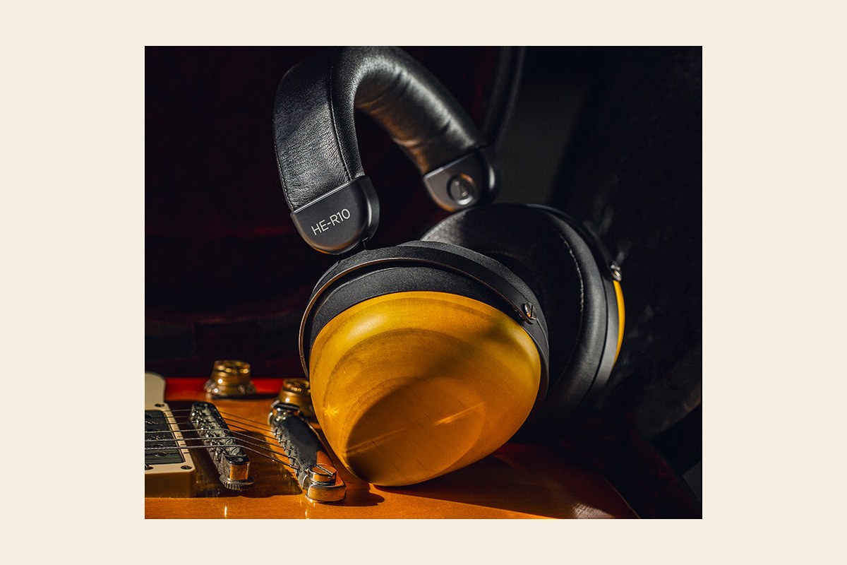 Wooden-cup headphones resting on an electric guitar