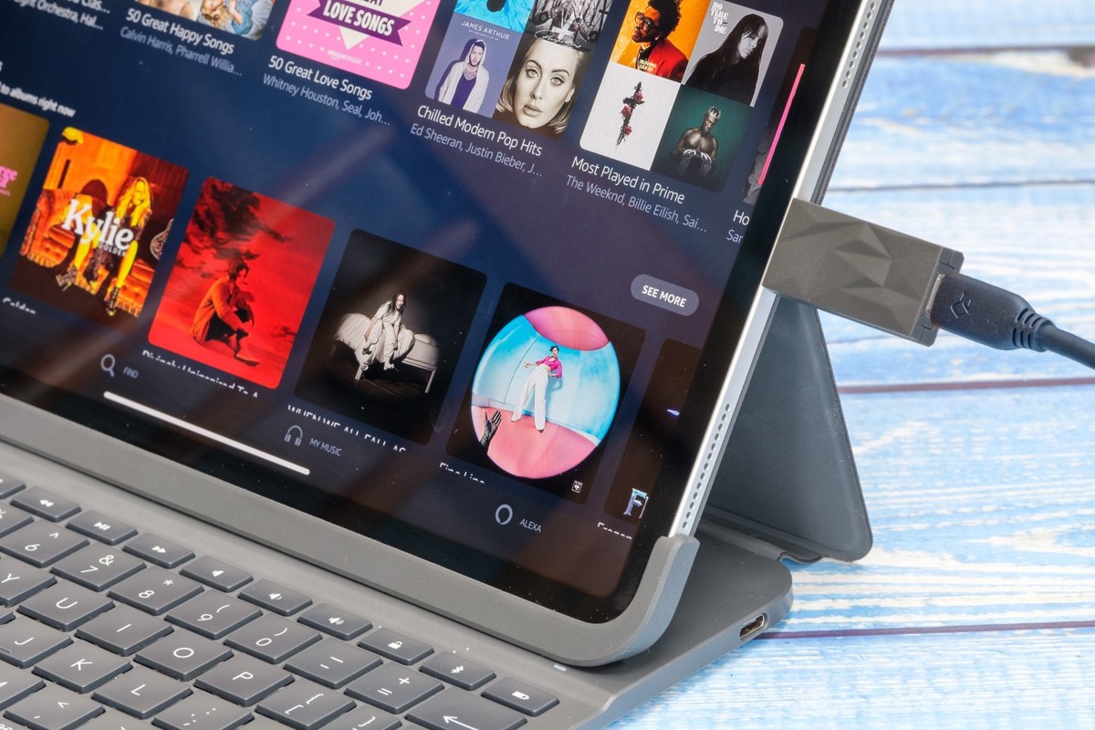 Anthracite filter plugged into a tablet showing a music library