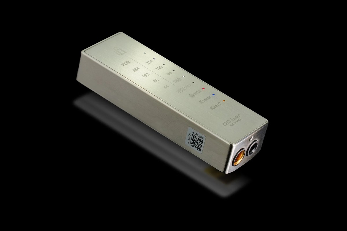 Brushed steel unit seen at three quarters on a black background, headphone sockets at the end