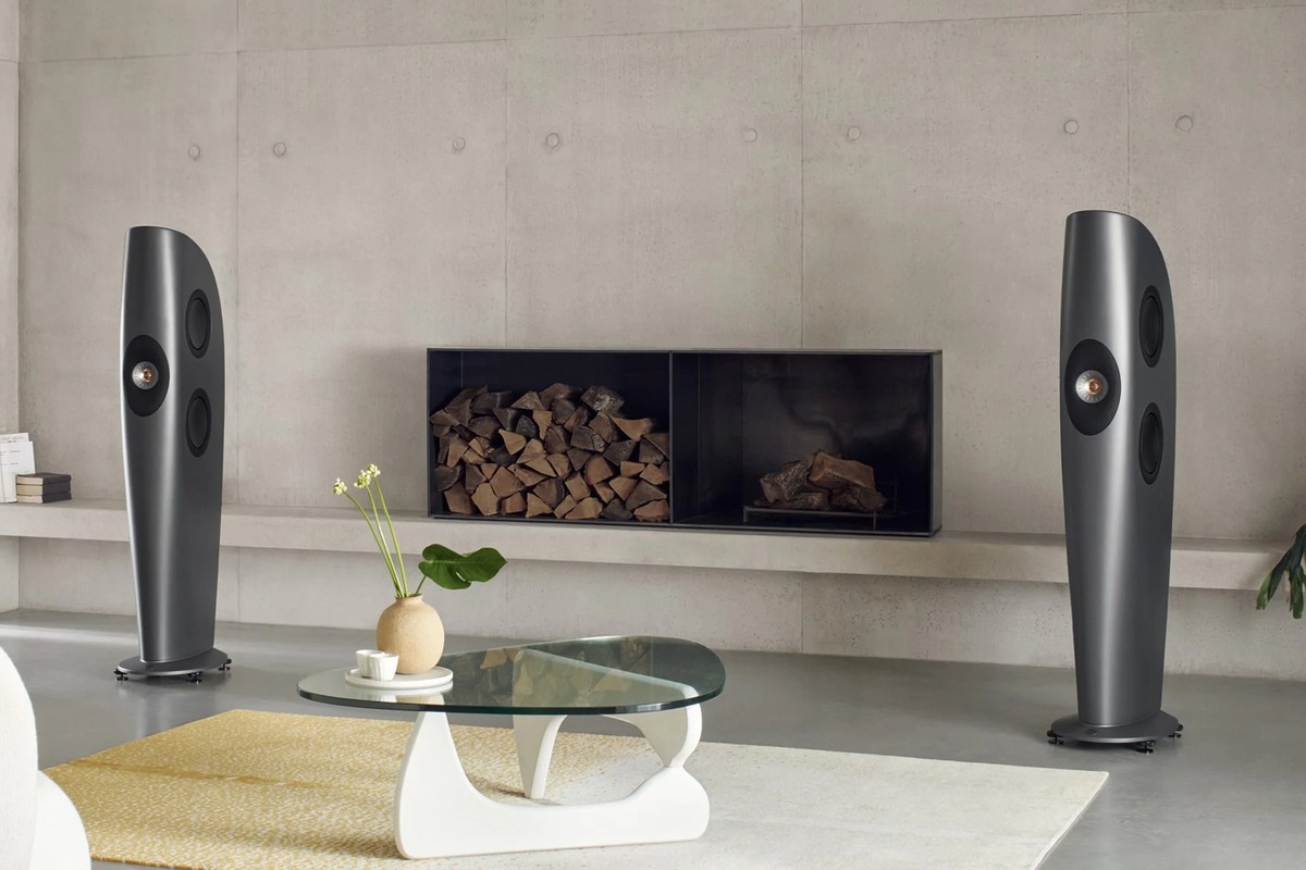 Pair of charcoal grey floorstanders in a living room with concrete walls