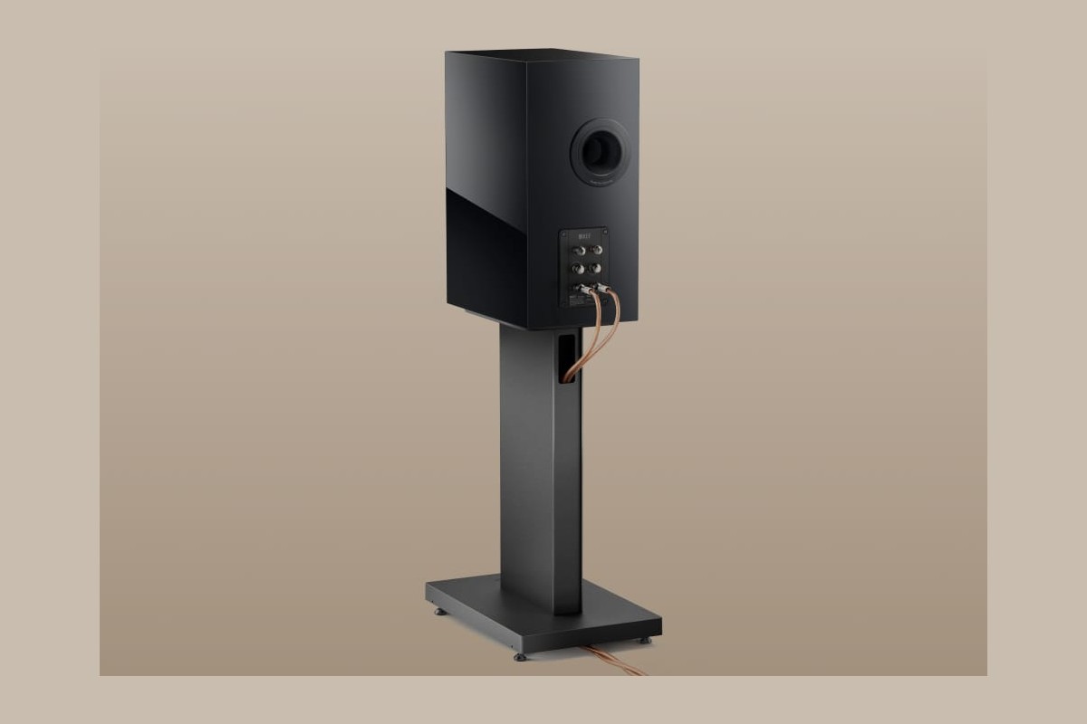 Rear view of a speaker on its stand, cable entering the column