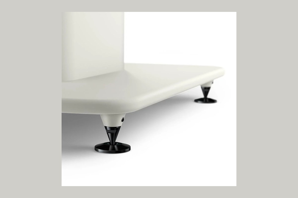 Base, adjustable spike and floor-protecting disc on a light background