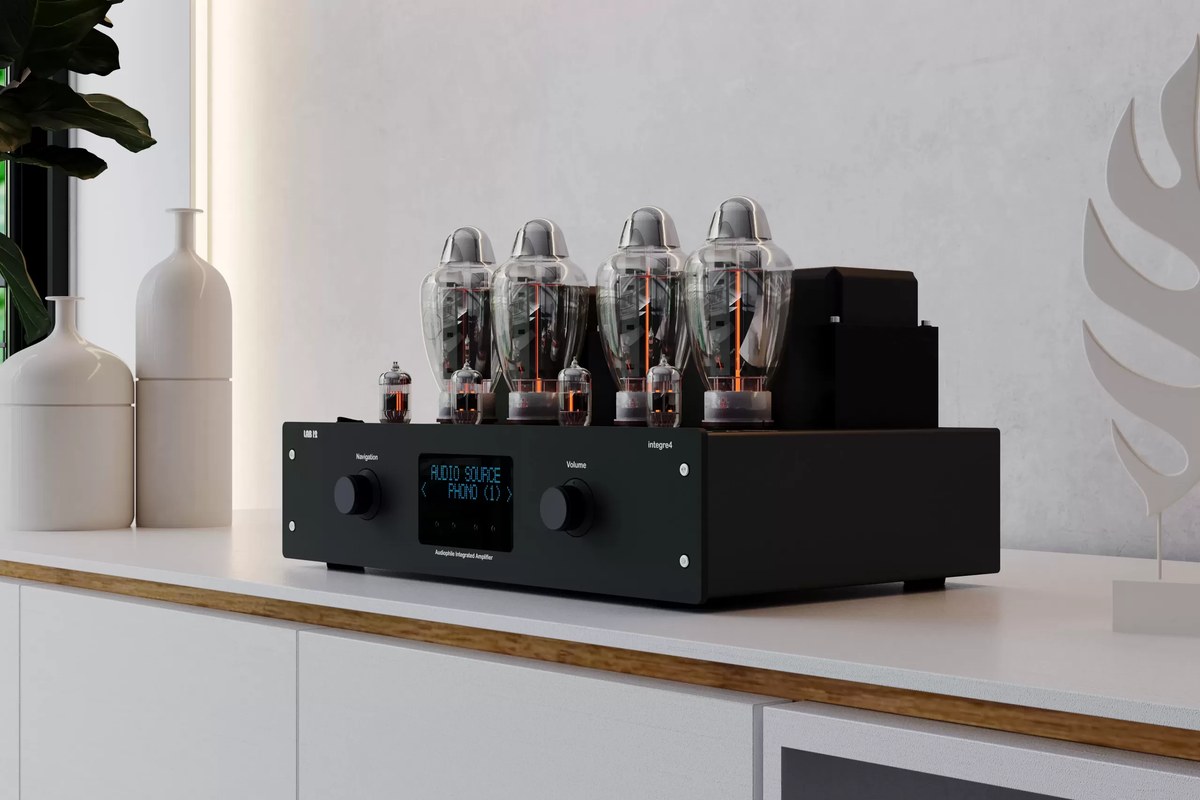 Black tube amplifier on a white sideboard in a bright living room