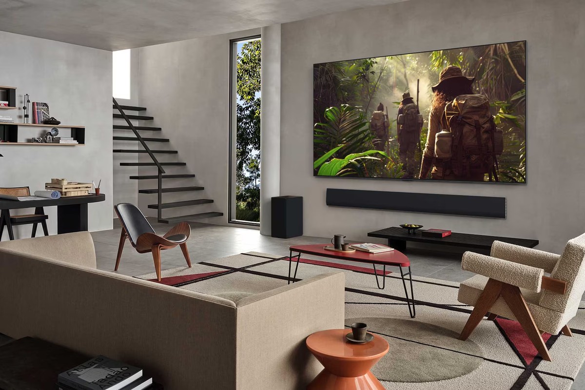 LG OLED evo television wall-mounted in a living room, with a soundbar