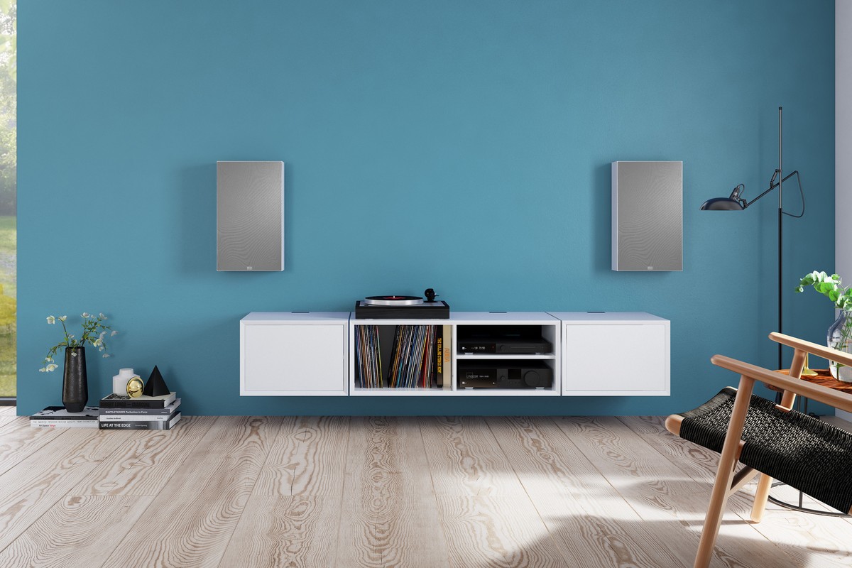 Pair of grey wall speakers above a hi-fi cabinet