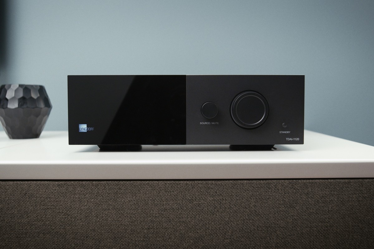 Black Lyngdorf amplifier on a sideboard