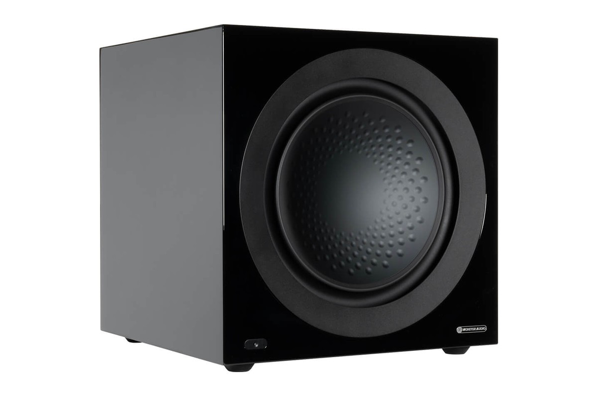 Gloss black subwoofer, three-quarter view, driver exposed