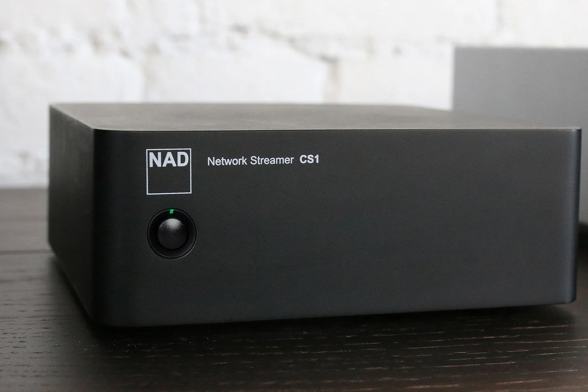 NAD CS1 from the front, with its front-panel button and green indicator lit