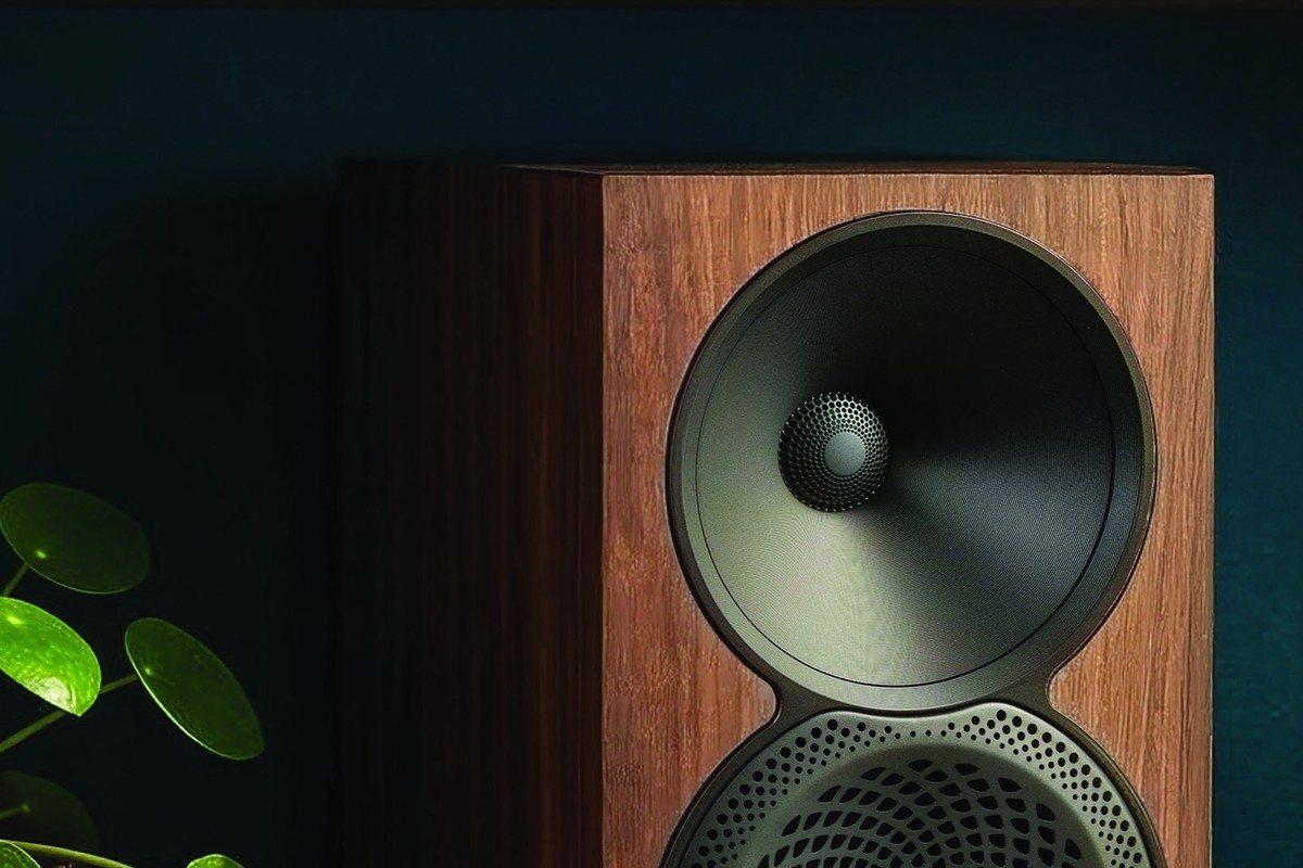 Walnut bookshelf speaker and its waveguide tweeter next to a plant