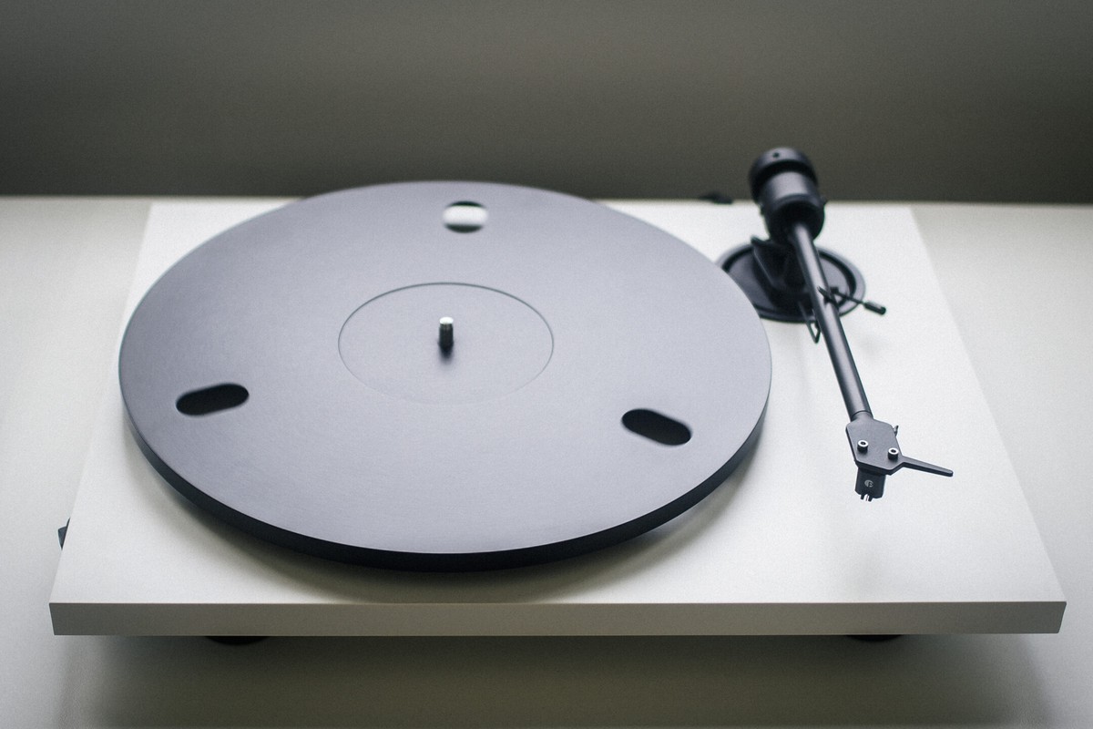 White turntable with black platter on a cabinet
