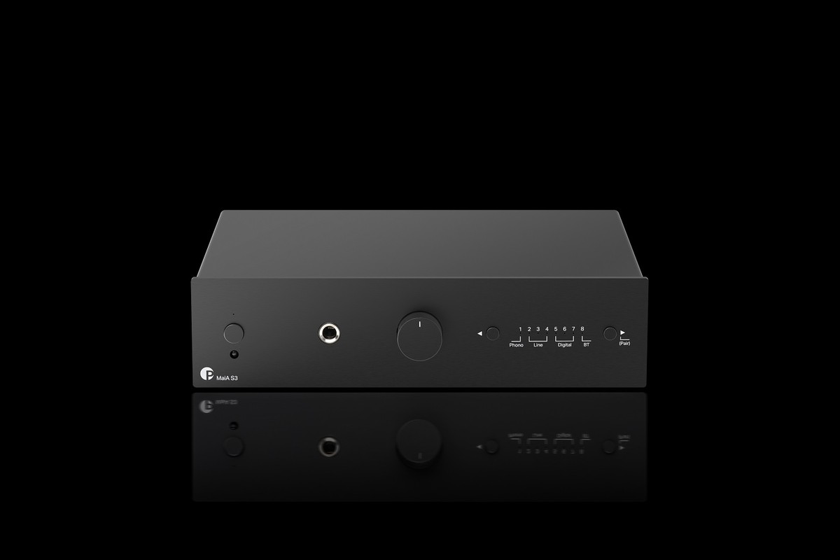 Black compact amplifier on a dark background