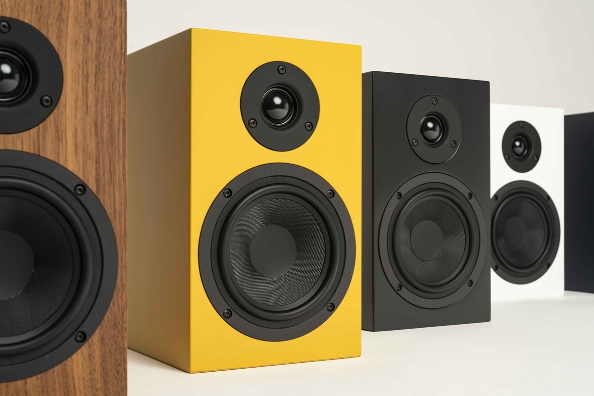 Yellow, black and white compact speakers
