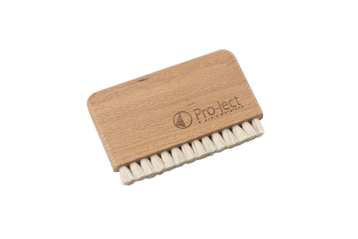 Light wood brush with white bristles and an engraved logo
