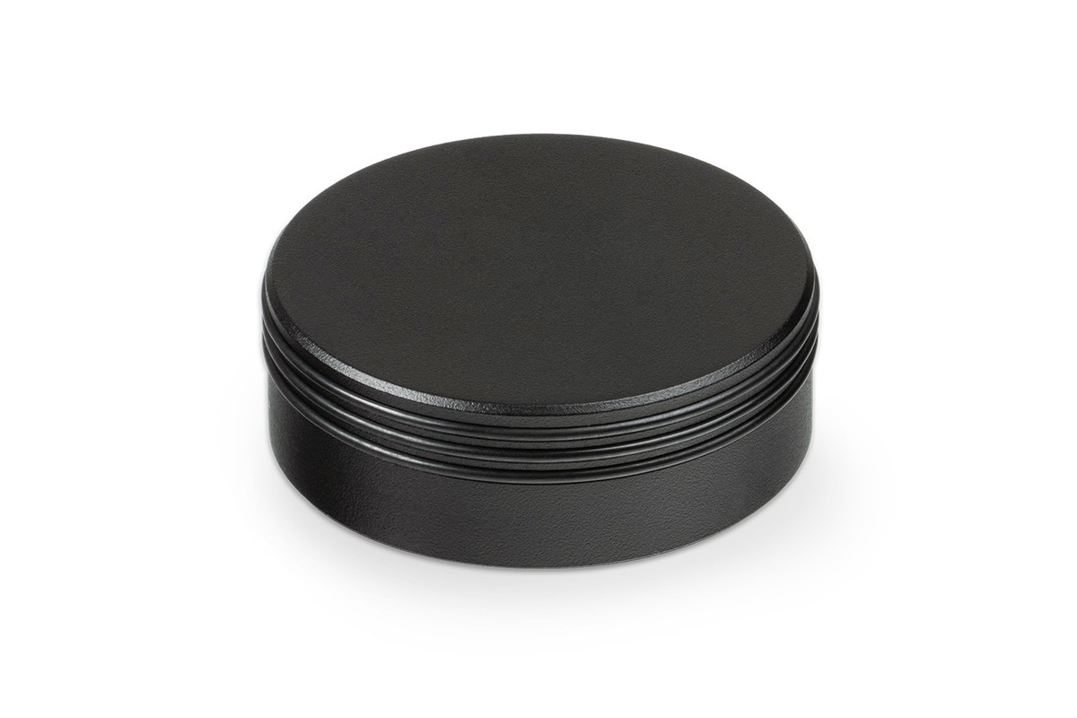 Black painted brass puck on a white background
