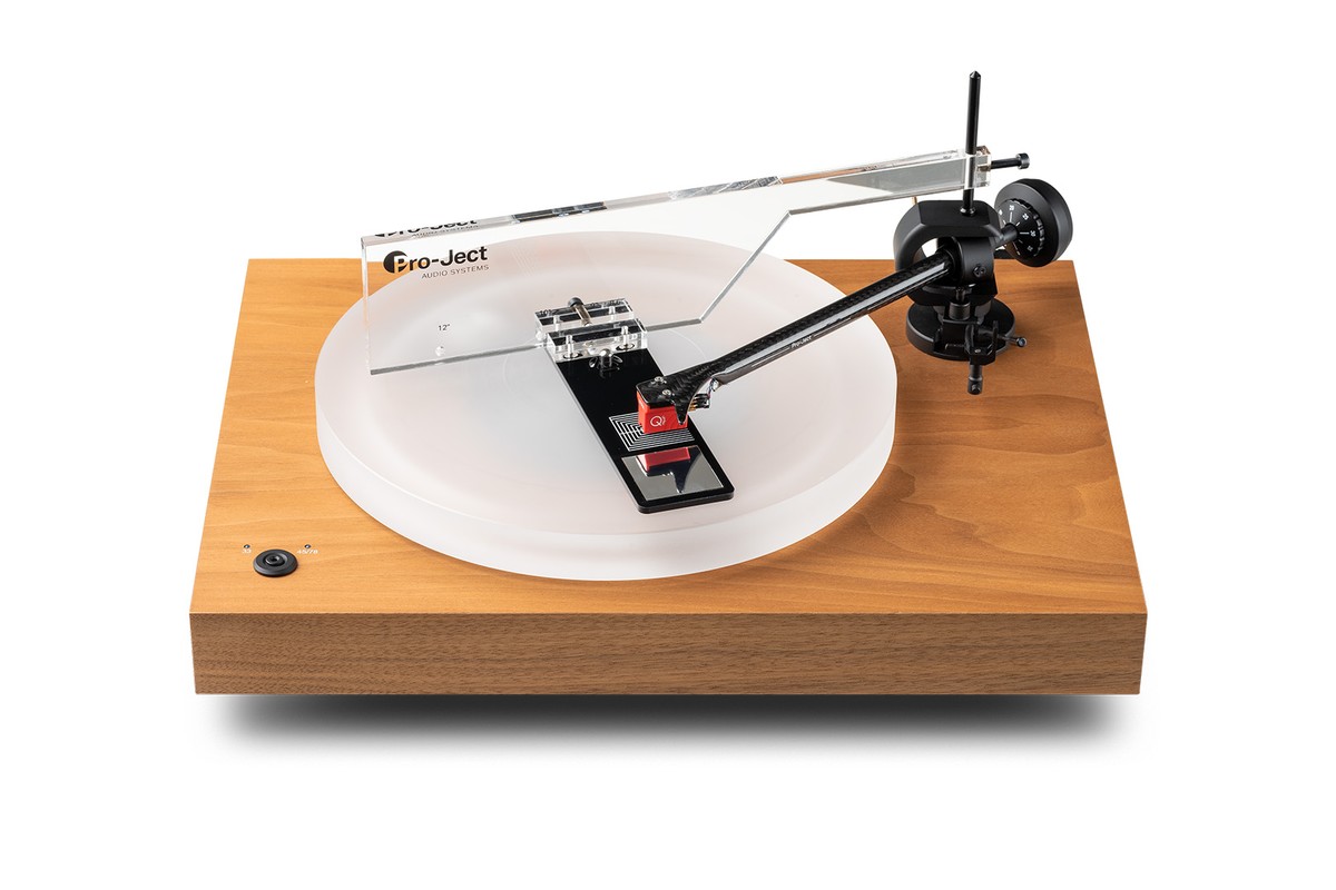 Tool fixed to the tonearm pivot on a wooden turntable