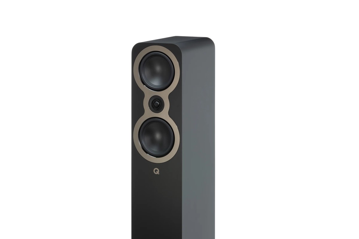Three-quarter view of a black floorstanding speaker with its two midbass drivers and tweeter