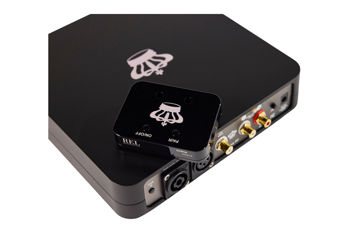 Receiver with PAIR and ON/OFF buttons resting on the transmitter