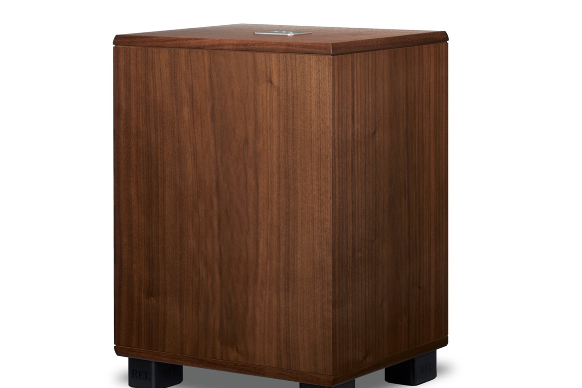 Walnut subwoofer at a three-quarter angle, showing the top and black feet