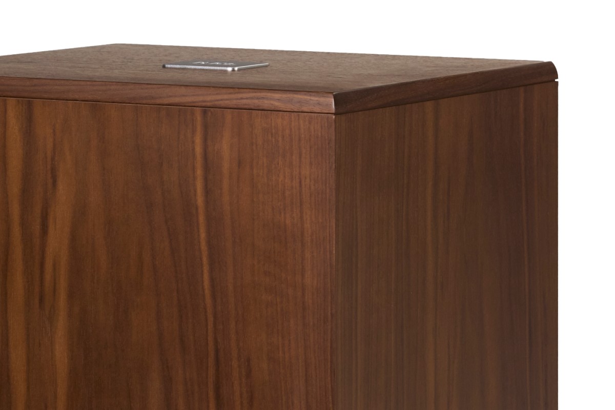 Close-up of the walnut top and its small metal badge
