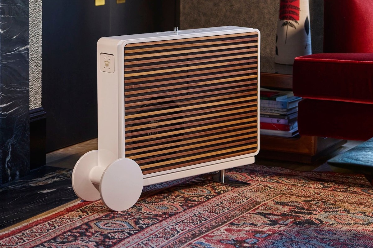 White subwoofer with wood slats on an oriental rug in a living room