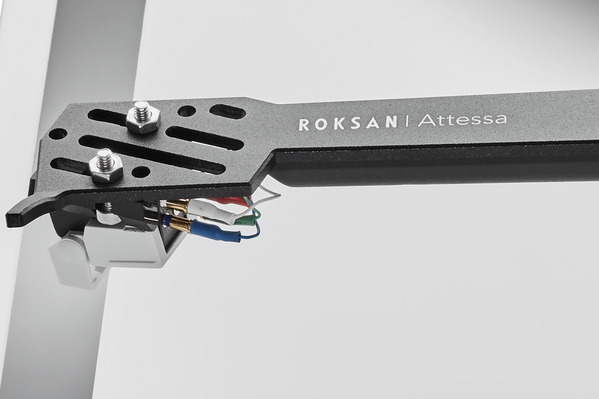 Close-up of a grey aluminium tonearm and its perforated headshell