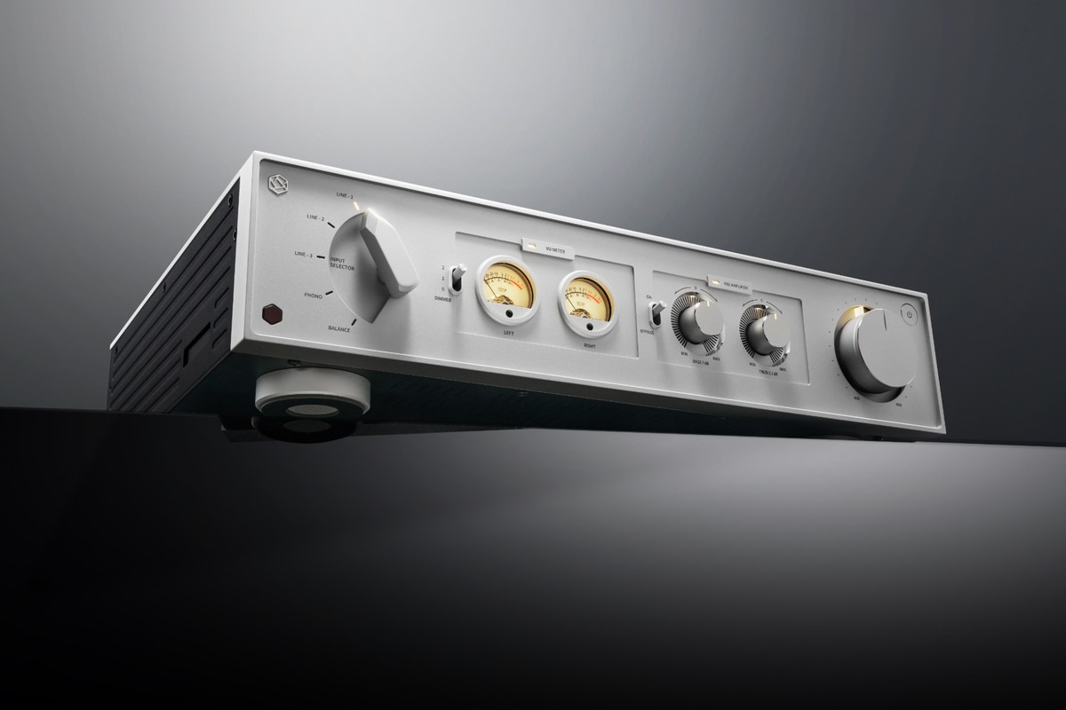 Silver front panel seen from below, two lit VU meters and a large volume knob