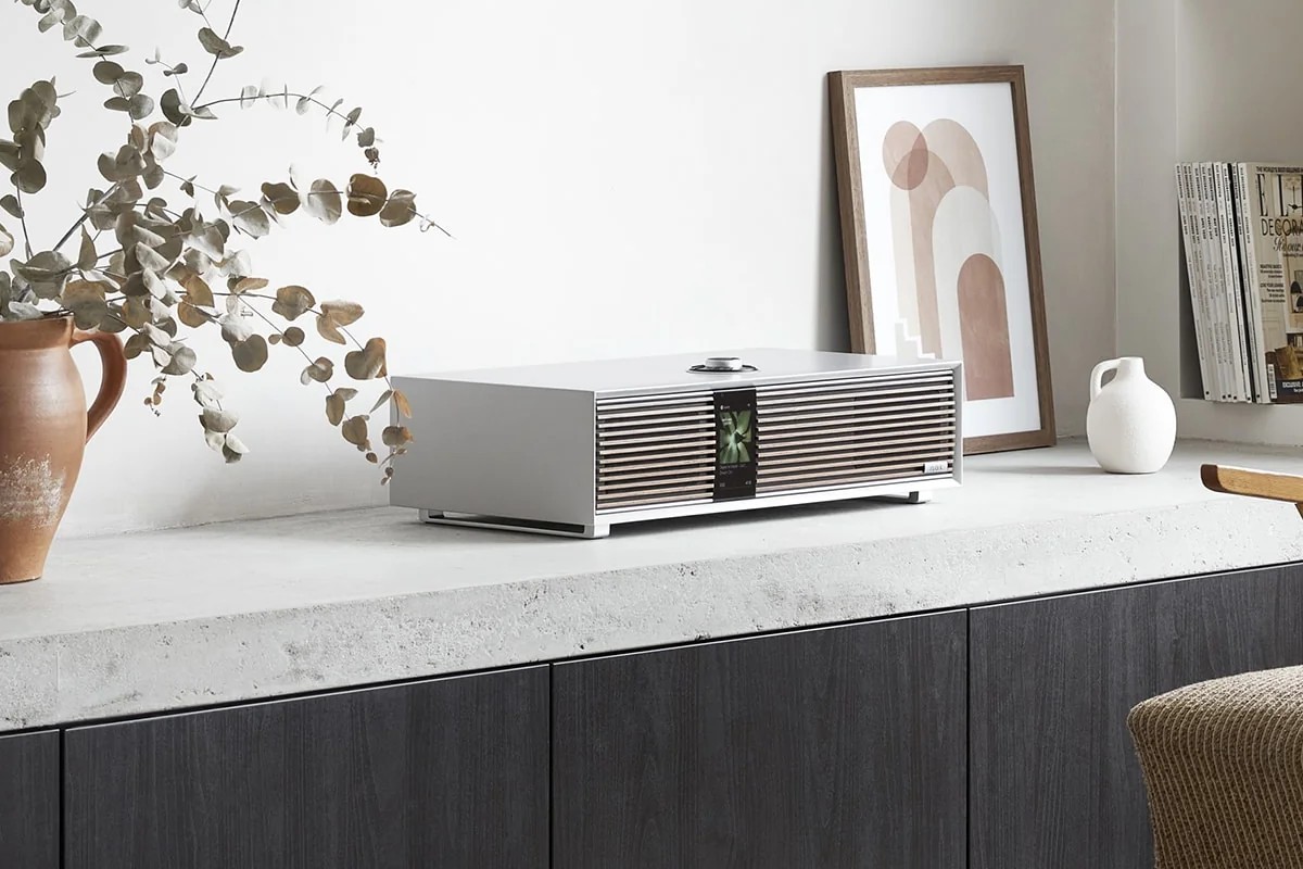 R410 Soft Grey on a light concrete worktop in front of an anthracite cabinet, eucalyptus branch beside it