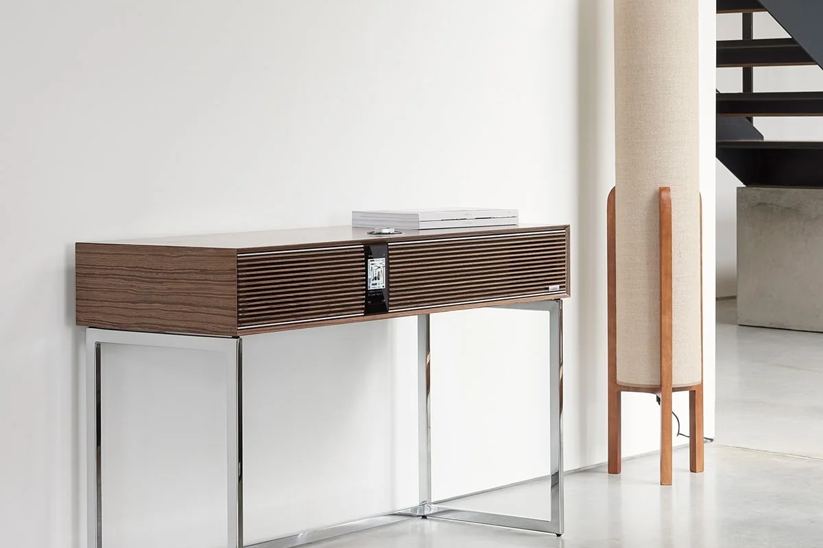 Walnut radiogram in a bright hallway, next to a black staircase and a linen light