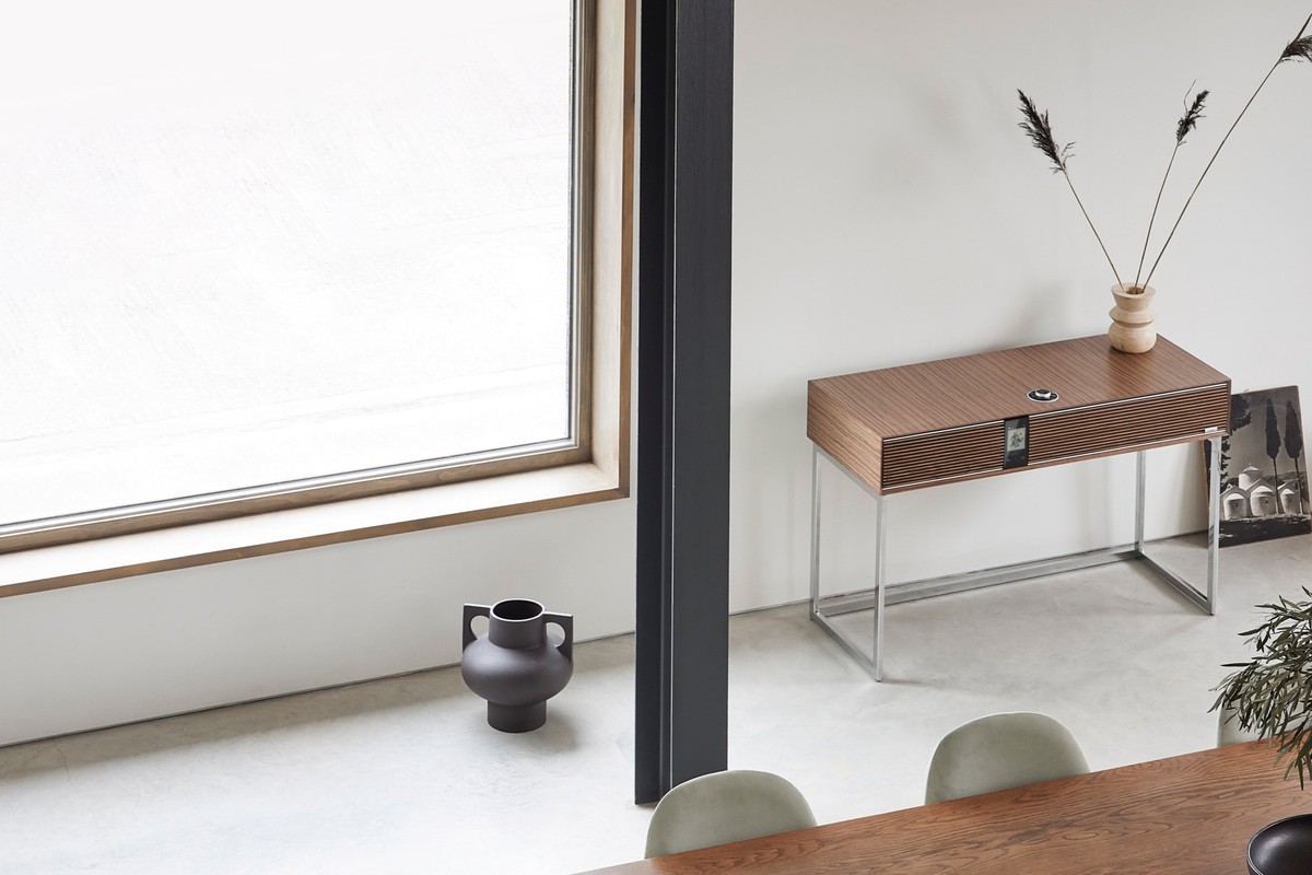 Walnut radiogram in a dining room, near a large window and a wooden table