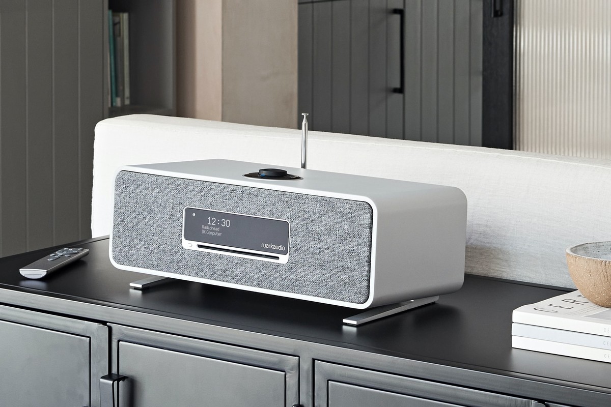 R3S Soft Grey on a black sideboard in front of a cream sofa, remote control beside it